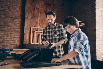 Portrait successful craftsmen occupation hobby fix hardwood touch tools helper support son kid glasses master explain beard checkered shirt trendy stylish modern indoors glasses goggles protective