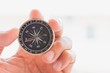 © TECHNOLOGY FACTORY - man holding compass on blurred background. for activity lifestyle