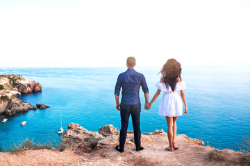 Romantic couple on the rock near beautiful sea beach.