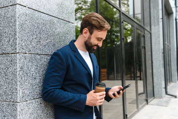 Wall Mural - Attractive young bearded man wearing jacket