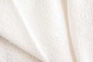 Wall Mural - White soft fluffy towel texture background. White terry textile with crease.