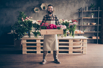 Full length body size view of his he nice attractive cheery cheerful content successful guy professional holding big box peony tulip diverse at industrial loft concrete style indoors