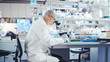 © Gorodenkoff - Senior Male Research Scientist is Working with Electron Microscope in a Modern High-Tech Laboratory. Genetics and Pharmaceutical Studies and Researches.