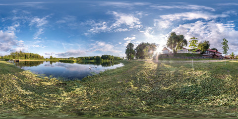 Wall Mural - full seamless spherical hdri panorama 360 degrees angle view on grass coast of huge lake or river in summer day with beautiful clouds near the country house in equirectangular projection, VR content