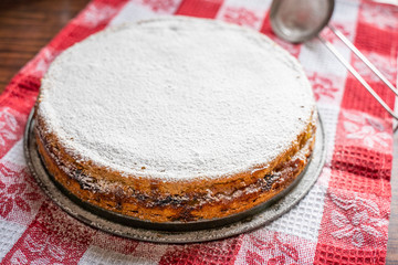 Wall Mural - Homemade Rhubarb and Apple Pie with Icing Sugar on the Red Towel