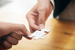 © ijeab - Hands holding jigsaw puzzles. Business partnershipt and teamwork concept.