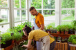 © Viacheslav Yakobchuk - Married couple taking care of plants in their shop.