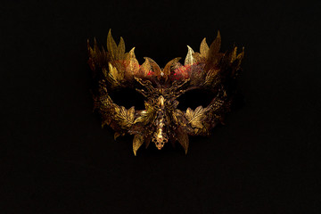 Cosplay, Venetian mask in gold and red with metallic pieces in the form of leaves. original and unique design, handmade crafts