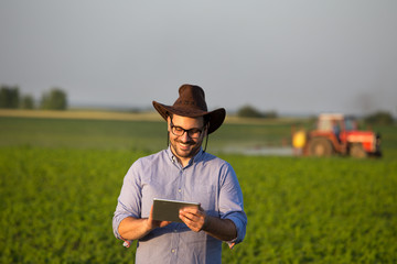 Sticker - Farmer with tablet in front of tractor in field