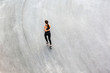 © khosrork - Top view of back side of young attractive athletic woman speed running on city asphalt and workout in the morning time on a sunny summer day. Female runner training outdoor. Copyspace, sport concept