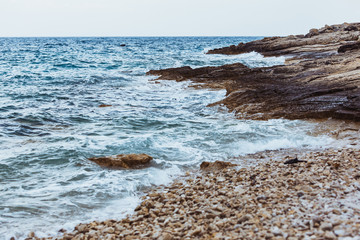 Wall Mural - view of rocky sea beach in storm weather