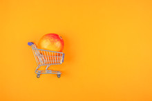 Mango Fruit In Shopping Cart On Orange Background