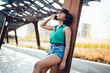 Cheerful African American hipster girl laughing during mobile phone conversation,happy young dark skinned woman having fun talk with friend on cellphone using international roaming connection outdoors