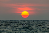Fototapeta Zachód słońca - The sun is falling into the sea. , The sky is orange And the sea is dark