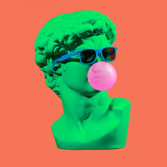 Wall Mural - Statue. Earphone. Isolated. Gypsum statue of David's head. Man. Creative. Plaster statue of David's head in blue sunglasses. Minimal concept art.