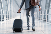 Business Trip. Businessman Carrying Suitcase, Back View