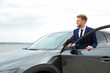 © New Africa - Young successful man near modern car outdoors
