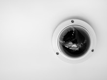 CCTV System Security. Close-up Round CCTV Camera On Ceiling Isolated On White Background.