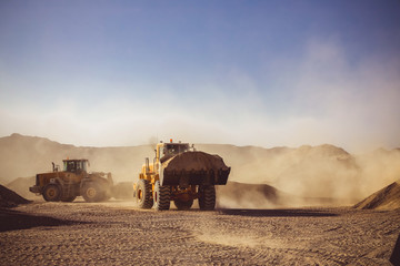 Bulldozers and earthmovers working in quarries