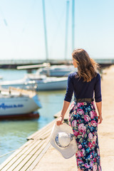 Beautiful girl in a dress on the beach, fashion woman, sea, sunny island