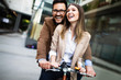 © NDABCREATIVITY - Young couple having fun in the city and ride a bicycle