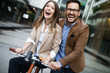 © NDABCREATIVITY - Young couple having fun in the city and ride a bicycle