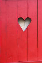 Close On A Heart-shaped On A Red Wooden Shutter