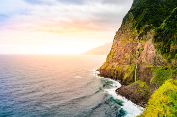 Wall Mural - Beautiful wild coast scenery view with Bridal Veil Falls (Veu da noiva) at Ponta do Poiso in Madeira Island. Near Porto Moniz, Seixal, Portugal.