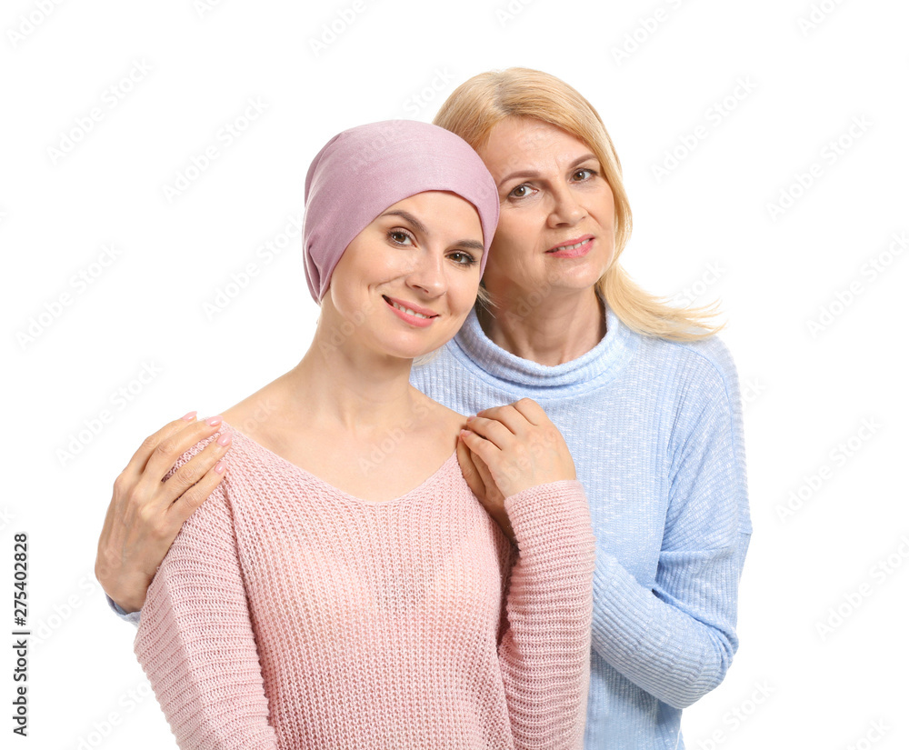 Woman after chemotherapy with her mother on white background