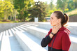 © Pixel-Shot - Sporty young woman checking her pulse outdoors