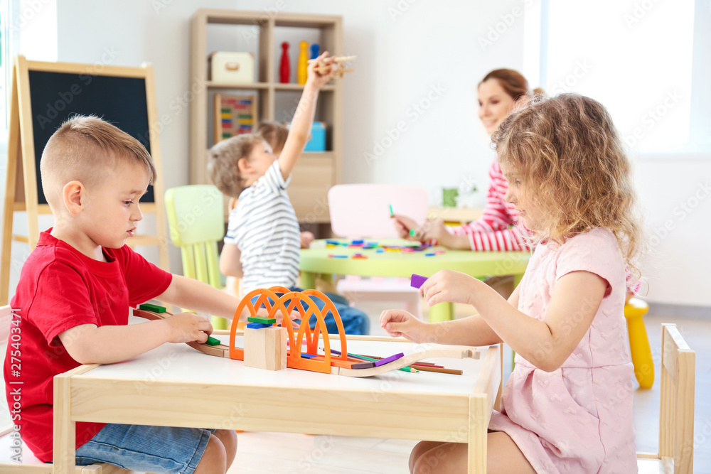Cute little children playing in kindergarten