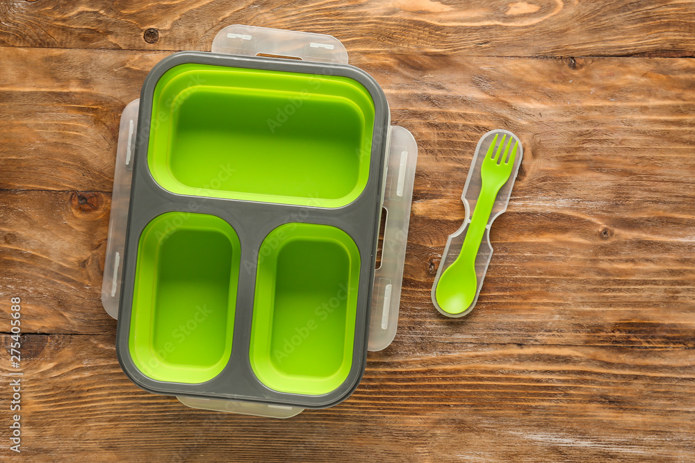 Plastic lunch box on wooden background