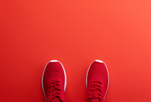 A Studio Shot Of Pair Of Running Shoes On Red Background. Flat Lay.