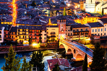 Wall Mural - Aerial view of the old town Verona, Italy. Illuminated bridge with other landmarks