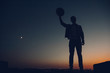 © Andriy - Silhouette of a man's portrait, watching the sunset over the city. Urban man with hat. Good looking