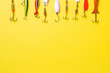 Fishing hooks and baits in a set for catching different fish on a yellow background with copy space. Flat lay