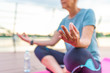 © Dragana Gordic - Fitness sport woman in fashion sportswear doing yoga fitness exercise outdoor. Mature woman in yoga position meditates near river at sunset. Mature woman doing yoga at park