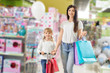 © serhiibobyk - Friendly family looking at camera while buying toys in store