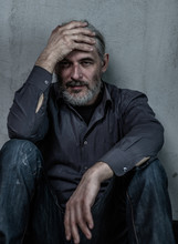 Portrait Of A Homeless Man With A Gray Hair On Dark Background. Empty Space For Text