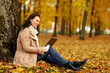© Syda Productions - season, technology and people concept - beautiful happy young woman with tablet pc computer at autumn park