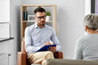 © Syda Productions - geriatric psychology, mental therapy and old age concept - senior woman patient and psychologist with clipboard taking notes at psychotherapy session