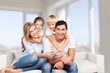 © BillionPhotos.com - Beautiful smiling family sitting at sofa at home