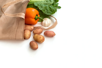 Zero waste use less plastic concept / Fresh vegetables organic in eco cotton fabric bags on wooden table - white tote canvas cloth bag from market free plastic shopping