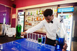 © AS Photo Family - African american bartender at bar making coctails on shots. Alcoholic beverage preparation.