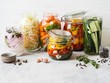 Pickled vegetables. Salting various vegetables in glass jars for long-term storage. Preserves vegetables in glass jars. Variety fermented green vegetables on table