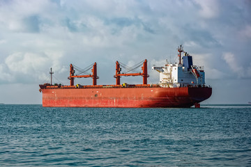 bulk carrier vessel is awaiting loading of bauxite ore at outer anchorage of kamsar port, guinea, we