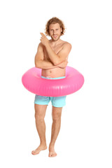 Canvas Print - Attractive young man in swimwear with pink inflatable ring on white background