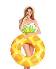 Poster - Beautiful young woman in stylish bikini with pineapple inflatable ring on white background