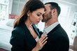 © Artem - The business couple in suits kissing in the apartment