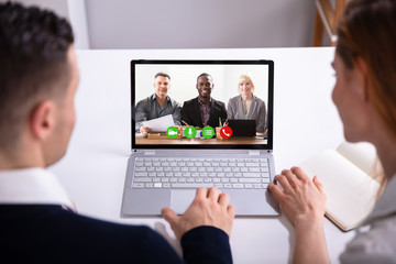 Wall Mural - Businesspeople Video Conferencing On Laptop